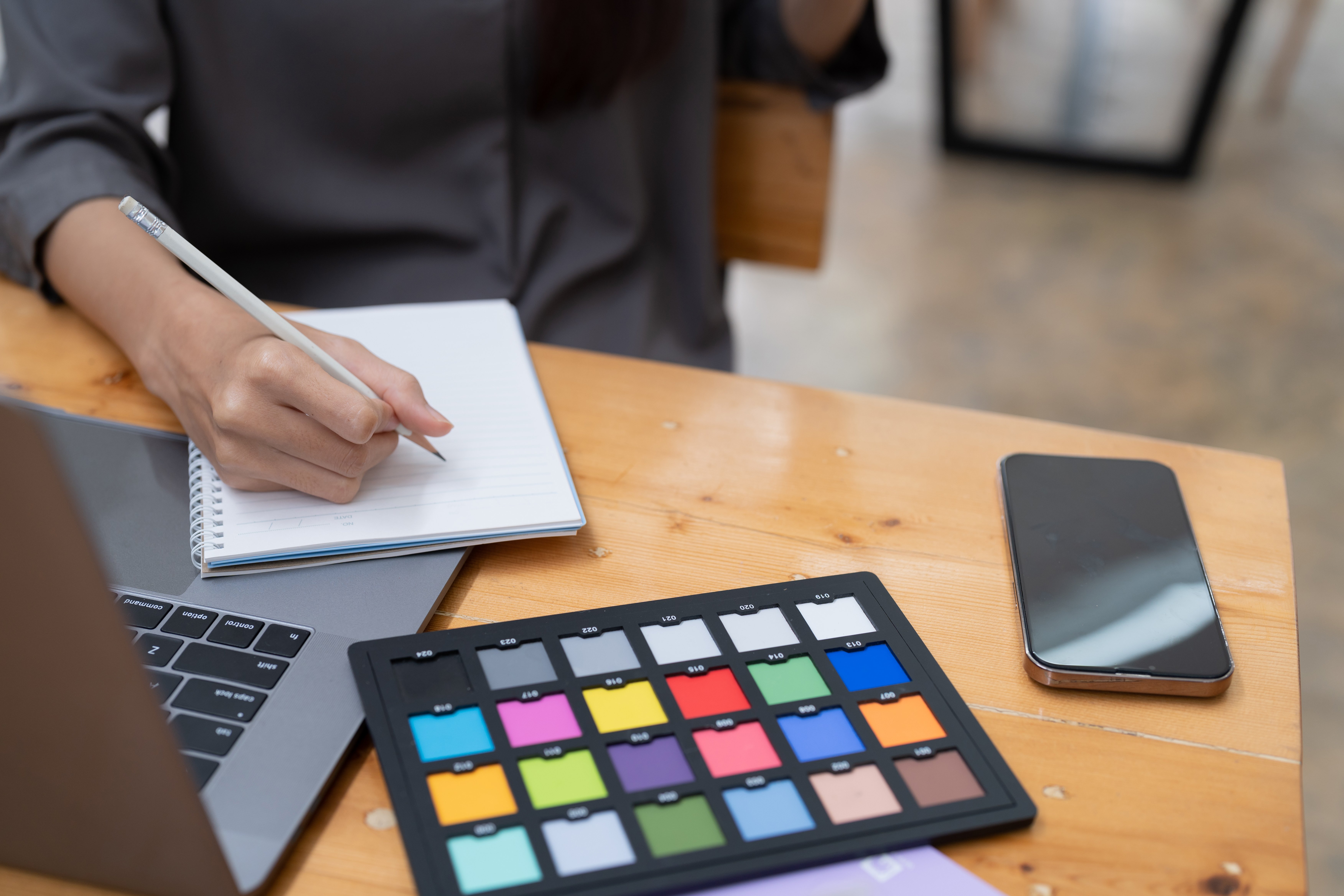 midsection-woman-using-calculator-while-sitting-table